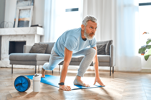 Middle Age Man Doing Yoga in living room
